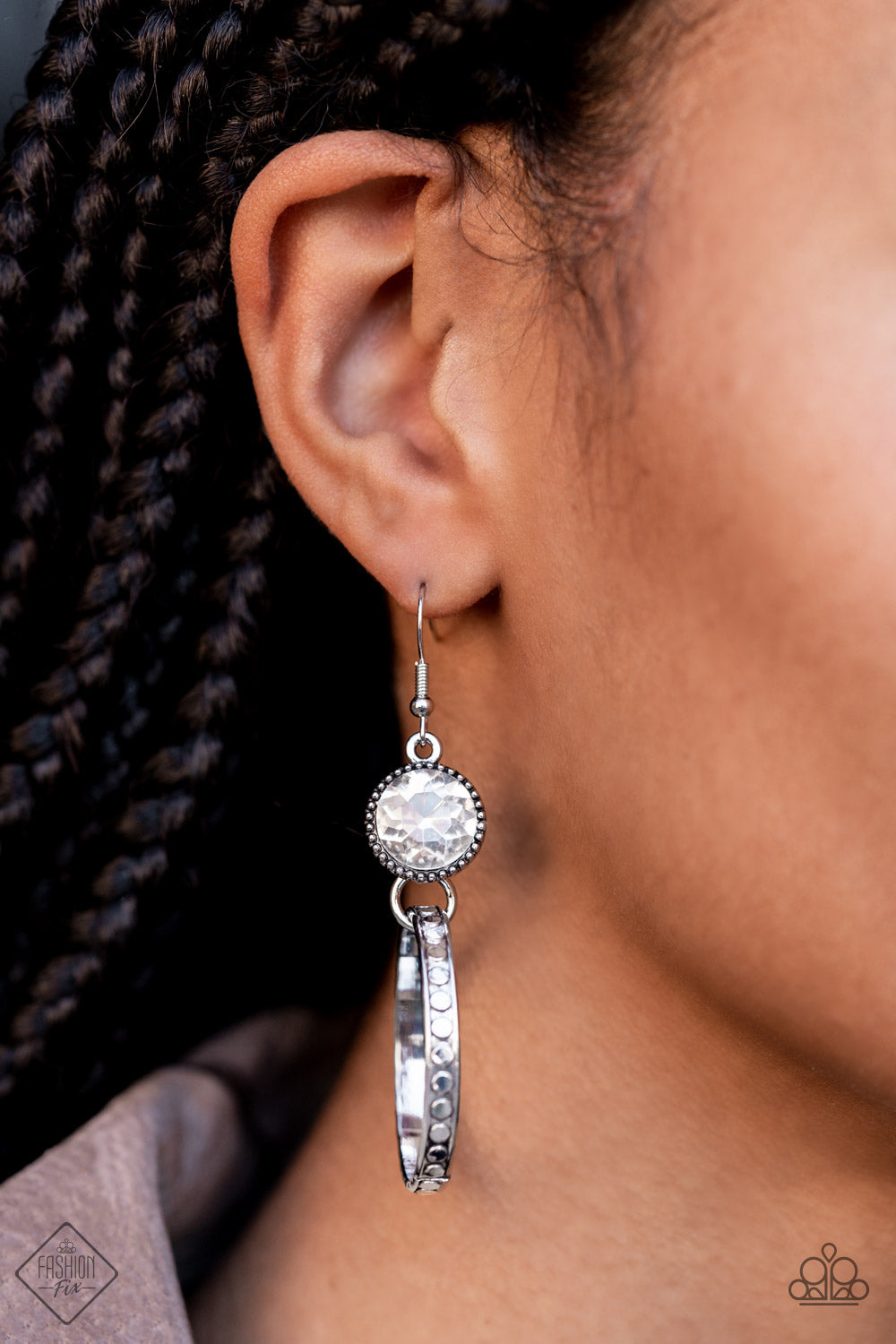 Standalone Sparkle White Earring - Paparazzi Accessories  The outer edge of a silver ring is stamped with a flattened dot motif as it swings below a dramatic white rhinestone that sparkles inside a daintily dotted antiqued silver frame, creating an upscale, edgy modern lure. Earring attaches to a standard fishhook fitting.  Sold as one pair of earrings.