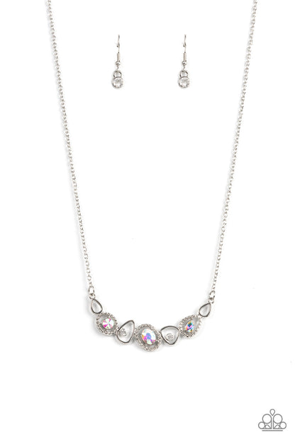 Celestial Cadence Multi Necklace - Paparazzi Accessories  An incandescent assortment of shiny silver frames, dainty white rhinestones, and oversized iridescent gems delicately coalesce into a statement-making sparkle below the collar. Features an adjustable clasp closure.  Sold as one individual necklace. Includes one pair of matching earrings.