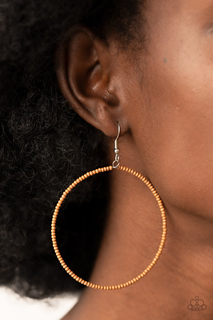 Basically Beaded - Brown Item #P5SE-BNXX-198XX Dainty brown seed beads are delicately threaded along a silver wire hoop, creating a neutral pop of color. Earring attaches to a standard fishhook fitting.  Sold as one pair of earrings.