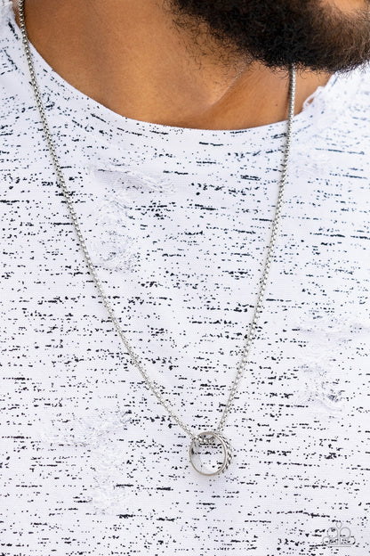 Emotion Potion Silver Necklace - Paparazzi Accessories  Embossed in a band of zigzagging texture, an antiqued silver ring glides along a strand of silver box chain across the chest in a rustic fashion. Features an adjustable clasp closure.  Sold as one individual necklace.