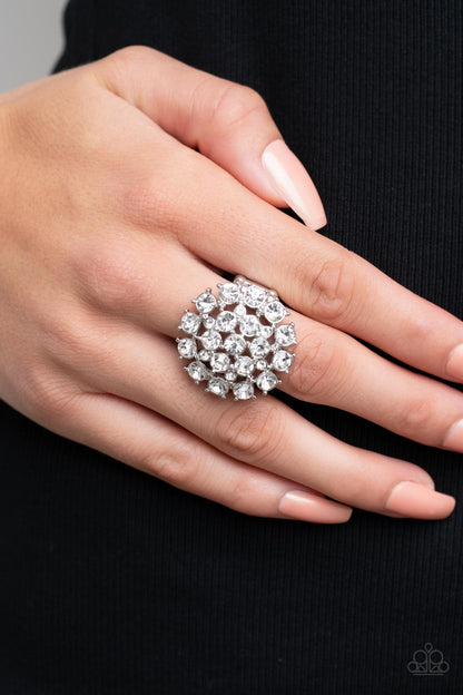 SELFIE-Confidence White Ring - Paparazzi Accessories  Featuring pronged silver fittings, an explosion of glassy white rhinestones sparkles atop the finger for a statement-making fashion. Features a stretchy band for a flexible fit.  Sold as one individual ring.