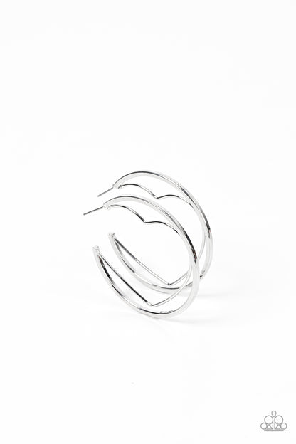 Love Goes Around Silver Hoop Earring - Paparazzi Accessories  A silver wire heart is encircled in an oversized silver hoop, resulting in a heart-stopping shimmer. Earring attaches to a standard post fitting. Hoop measures approximately 2" in diameter.  Sold as one pair of hoop earrings.