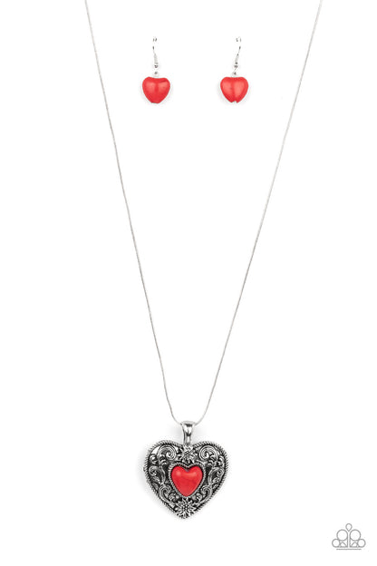 Wholeheartedly Whimsical Red Necklace - Paparazzi Accessories  Embossed in whimsical flowers and vines, a rustic silver heart frame is adorned with a red stone heart center for an adoring artisan finish as it glides along a rounded silver snake chain across the chest. Features an adjustable clasp closure.  Sold as one individual necklace. Includes one pair of matching earrings.