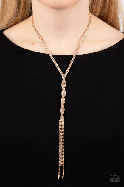 Impressively Icy Gold Necklace - Paparazzi Accessories  Golden ribbons of glassy white rhinestones loop around the neck and delicately twist into an icy tassel down the chest. Features an adjustable clasp closure.  Sold as one individual necklace. Includes one pair of matching earrings.