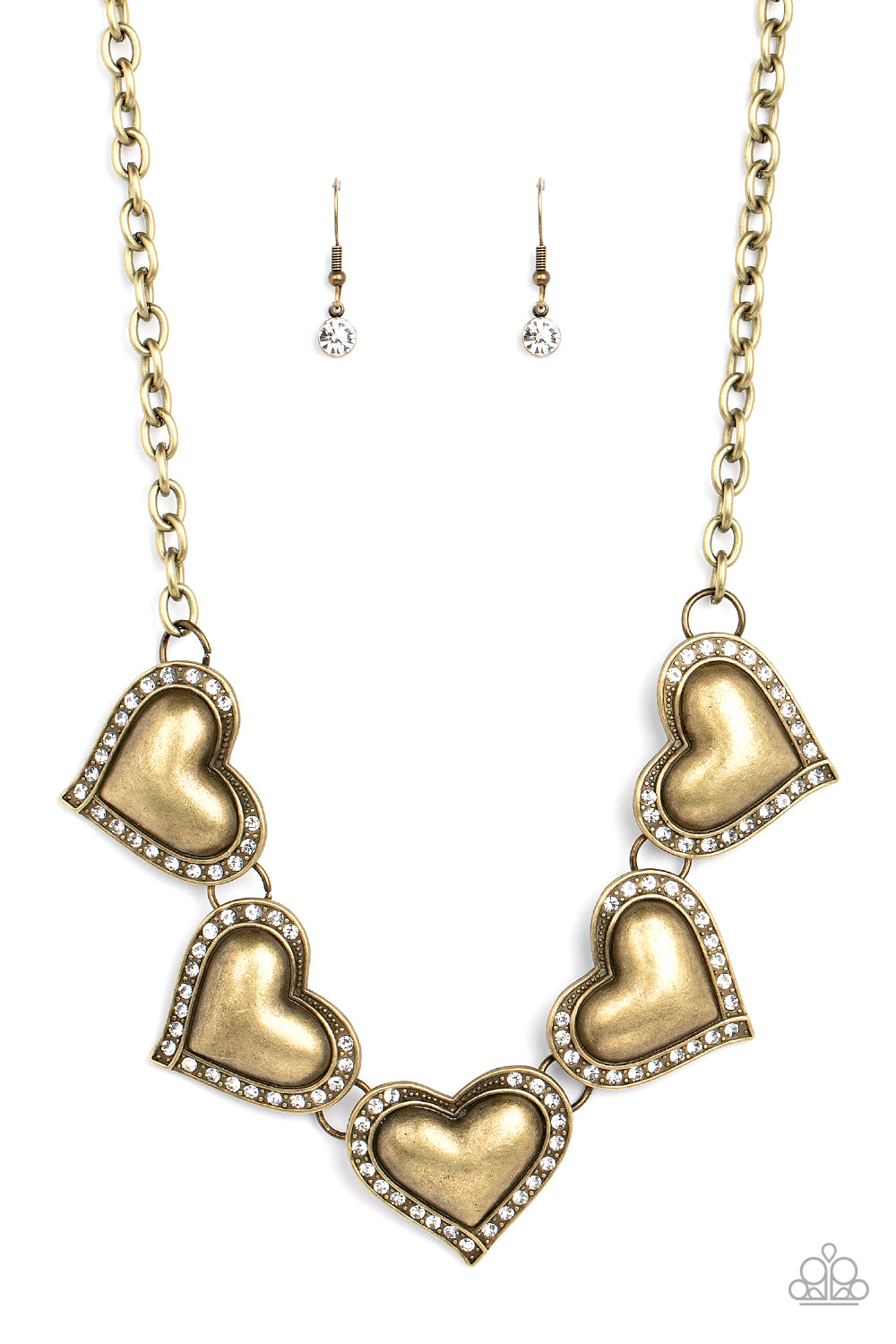 Kindred Hearts - Brass Item #P2WH-BRXX-173XX Bordered in glassy white rhinestones, an oversized collection of beveled brass heart frames delicately links below the collar for a dramatically romantic look. Features an adjustable clasp closure.  Sold as one individual necklace. Includes one pair of matching earrings.