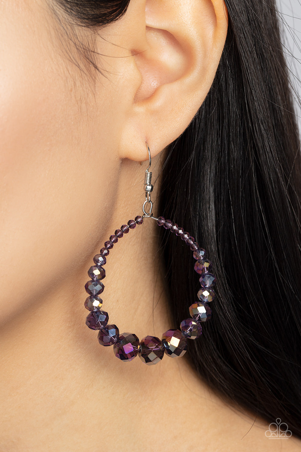 Astral Aesthetic Purple Earring - Paparazzi Accessories  Featuring a flashy faceted finish, purple gems with a kaleidoscopic overlay gradually increase in size as they glide along a wire hoop, resulting in a stellar teardrop. Earring attaches to a standard fishhook fitting.  Featured inside The Preview at GLOW!  Sold as one pair of earrings.