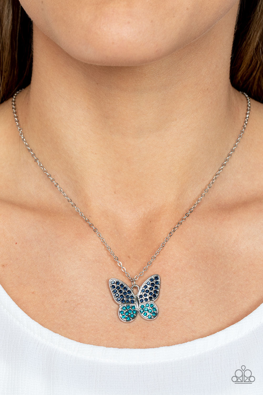 Flutter Forte Blue Butterfly Necklace - Paparazzi Accessories  Dotted in Skydiver and Harbor Blue rhinestones, a whimsical silver butterfly flutters along a dainty silver chain below the collar for an enchanting fashion. Features an adjustable clasp closure.  Sold as one individual necklace. Includes one pair of matching earrings.