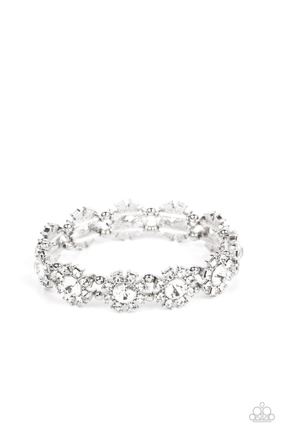 Premium Perennial White Bracelet - Paparazzi Accessories  Separated by pairs of dainty silver beads, rhinestone-dotted petals bloom from oversized white rhinestone centers along stretchy bands around the wrist for a flirtatious floral fashion.  Sold as one individual bracelet.