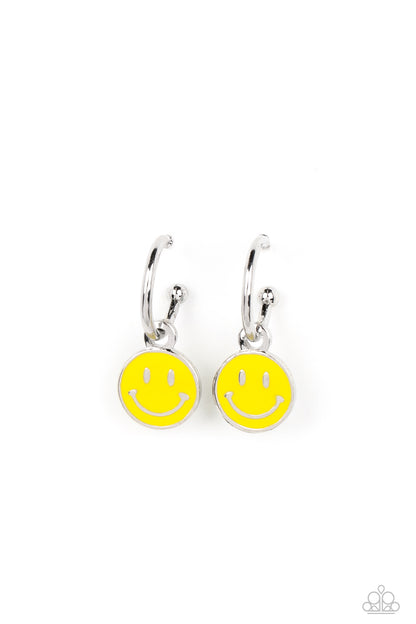 Subtle Smile Yellow Hoop Earring - Paparazzi Accessories  A small, skinny, silver hoop curves around the ear, where a silver ball is affixed to create the look of a barbell. A yellow disc slides along the hoop, cheerfully showcasing a silver smiley face that adorns its colorful surface. Earring attaches to a standard post fitting. Hoop measures approximately 1/2" in diameter.  Sold as one pair of hoop earrings.