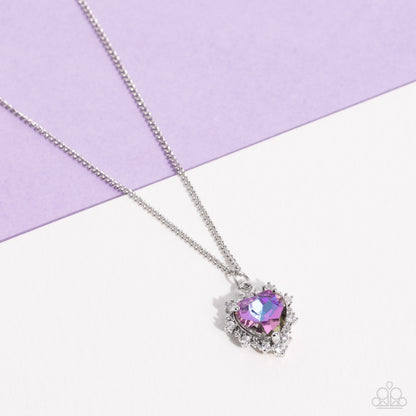 Be Still My Heart Purple Necklace - Paparazzi Accessories  Featuring a subtle UV shimmer, a purple heart gem, pronged in place, glides down the neckline on a dainty silver chain. Bordering the purple heart, a row of dainty white rhinestones creates additional shimmer to the romantic design. Features an adjustable clasp closure. Due to its prismatic palette, color may vary.  Sold as one individual necklace. Includes one pair of matching earrings.  P2DA-PRXX-135XX