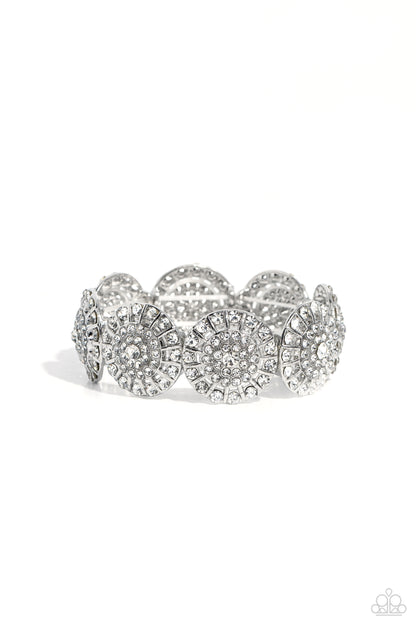 Executive Elegance White Stretch Bracelet - Paparazzi Accessories  Featuring a wheel motif, concaved silver discs embossed in an explosion of white rhinestones slide along a stretchy band around the wrist for a hint of dazzling refinement.  Sold as one individual bracelet.  P9RE-WTXX-576XX