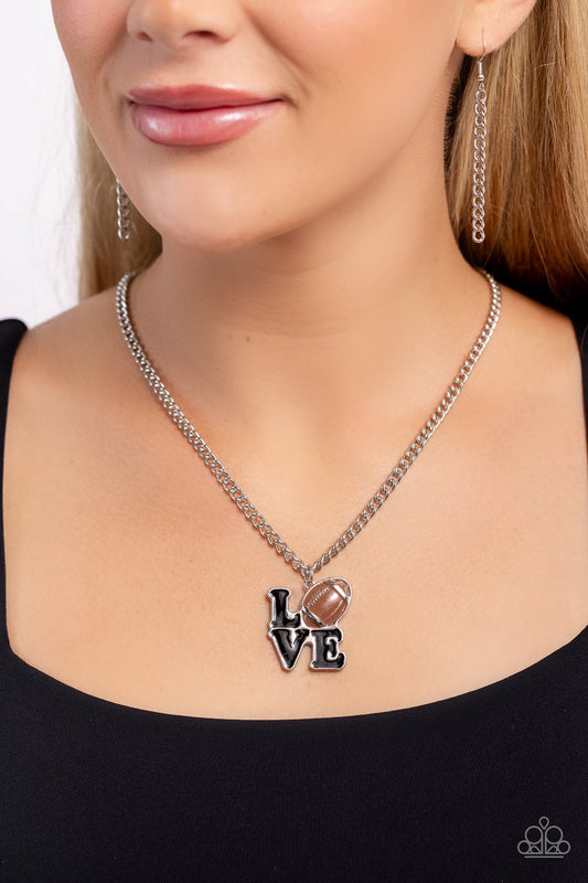 Tender Touchdown Brown Football Necklace - Paparazzi Accessories  Gliding along a classic silver chain, a black-painted word pendant spells out the word "LOVE" with a brown-painted and silver-detailed football replacing the "O" for a sports-inspired centerpiece. Features an adjustable clasp closure.  Sold as one individual necklace. Includes one pair of matching earrings.  P2WD-BNXX-100XX