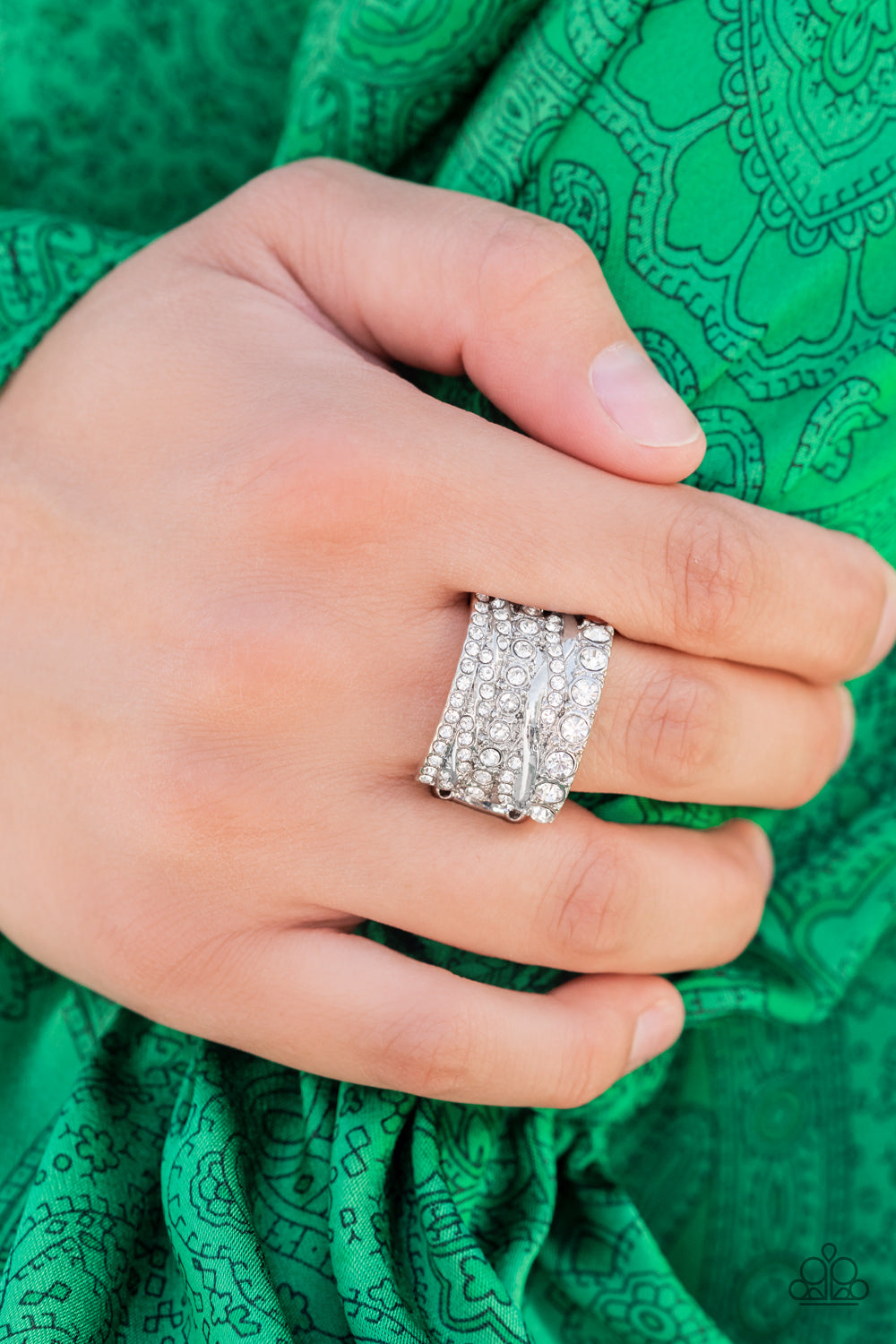 Exclusive Elegance - White Item #P4RE-WTXX-427XX Row after row of radiantly mismatched white rhinestones and glistening silver bands haphazardly stack across the finger, coalescing into a dramatic display of dazzle. Features a stretchy band for a flexible fit.  Sold as one individual ring.